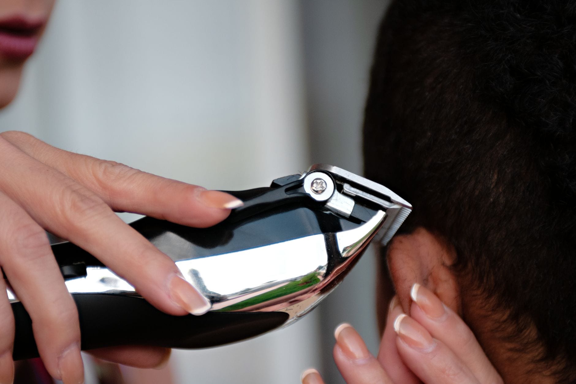 A barber lining up a haircut